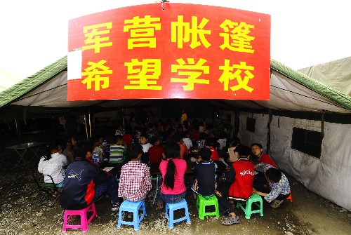 5月23日,災區的孩子在軍營帳篷希望學校內上課。 新華社記者 任勇 攝